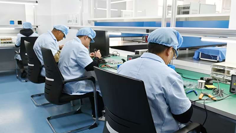 Technicians testing night vision optics with calibrated measurement equipment